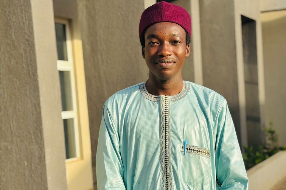 Khalifa Aliyu, Managing Director of Avraam, standing in front of Rayhaan University student hostel in Birnin Kebbi
